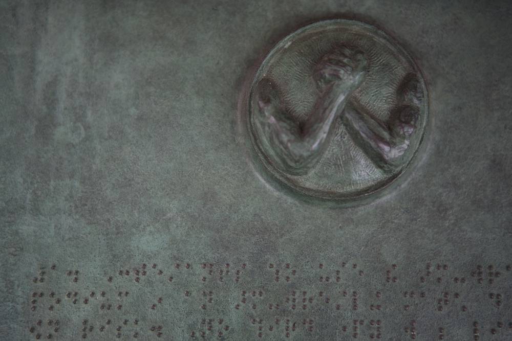 A detail of the medallion appearing on the Braille bronze plaques of the AWP
