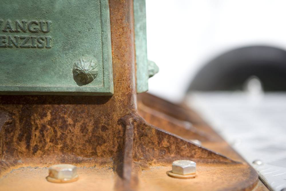 A close up showing the base of the table and bronze plaque attachments of the AWP