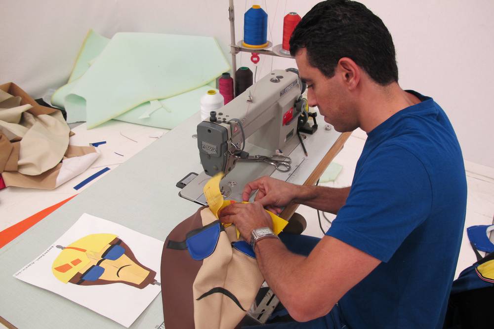 Local Algerian leather craftsman making leather components.