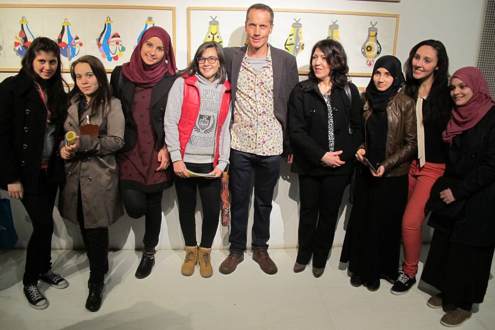 Exhibition opening evening with participating learners and teachers standing in front of their punching bag collages, 3 December 2014.