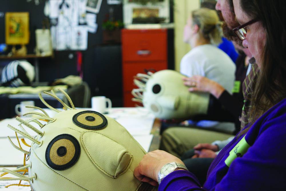 A teacher inspecting a punchbag example.